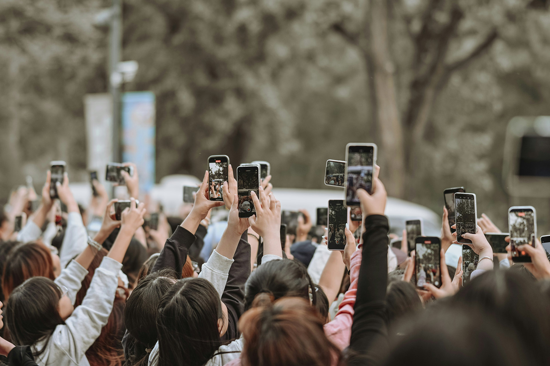 people holding high their smartphones