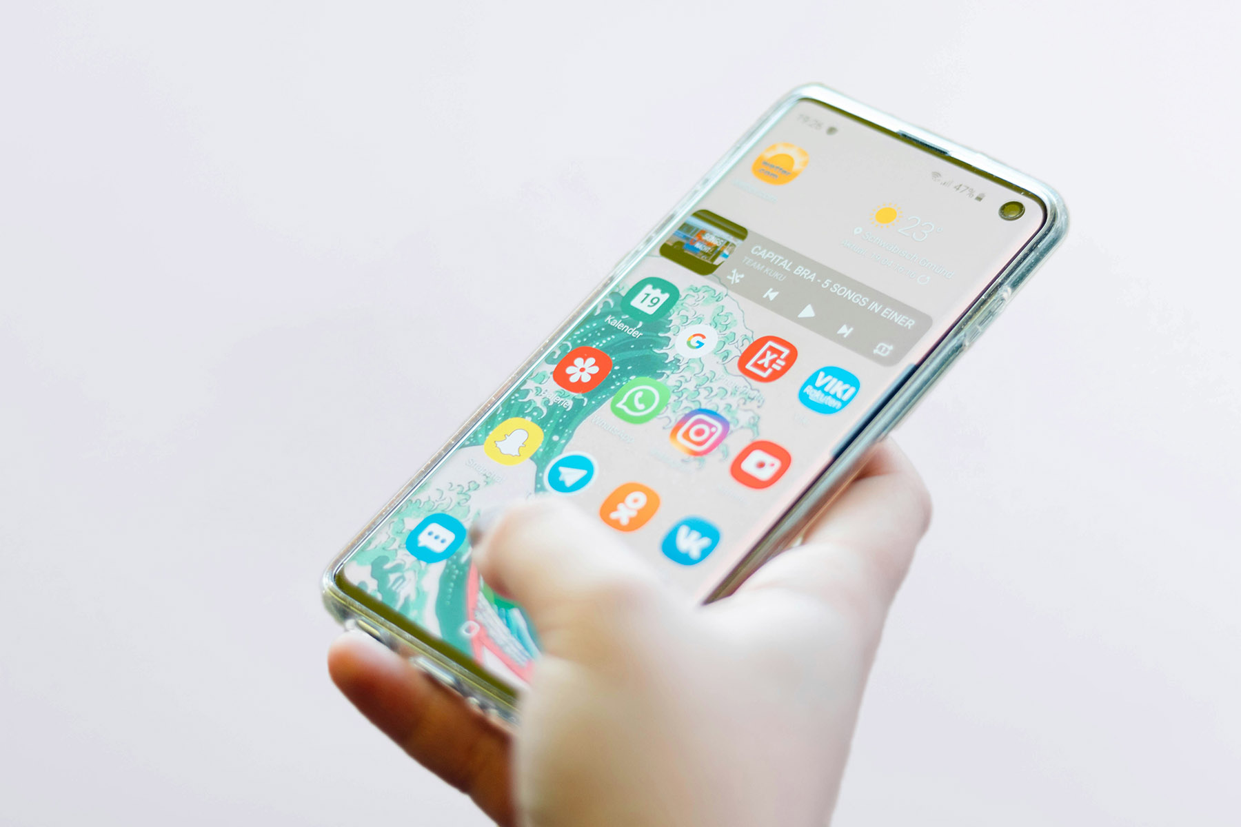 smartphone in hand with open apps